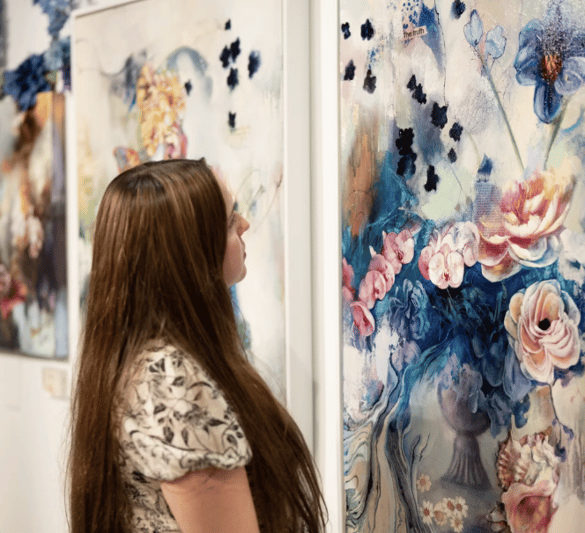 Woman looking at floral painting