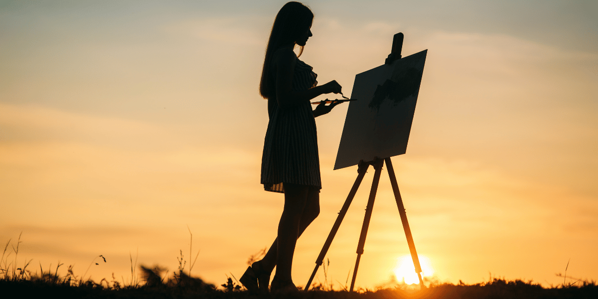 Woman painting a sunset