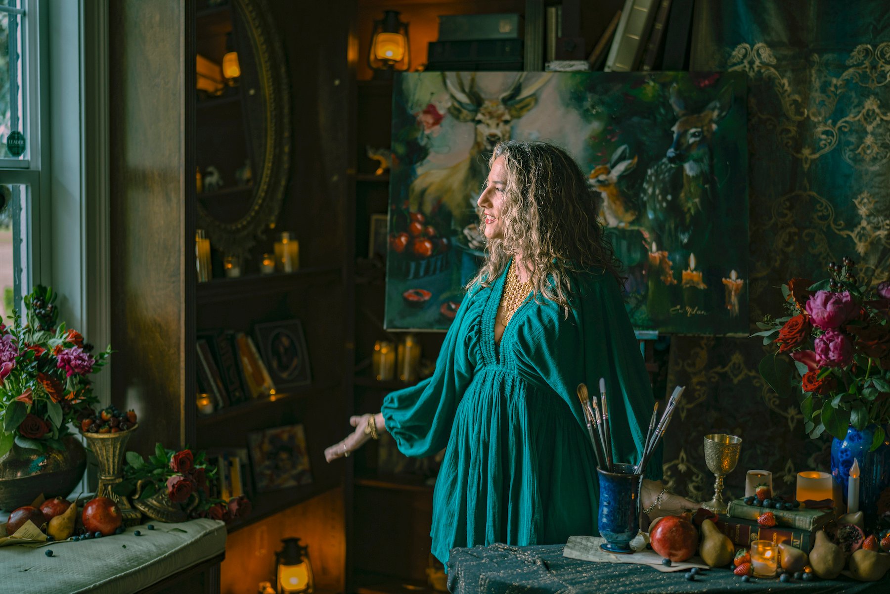 WOmen standing in green dress in dreamy dark room 